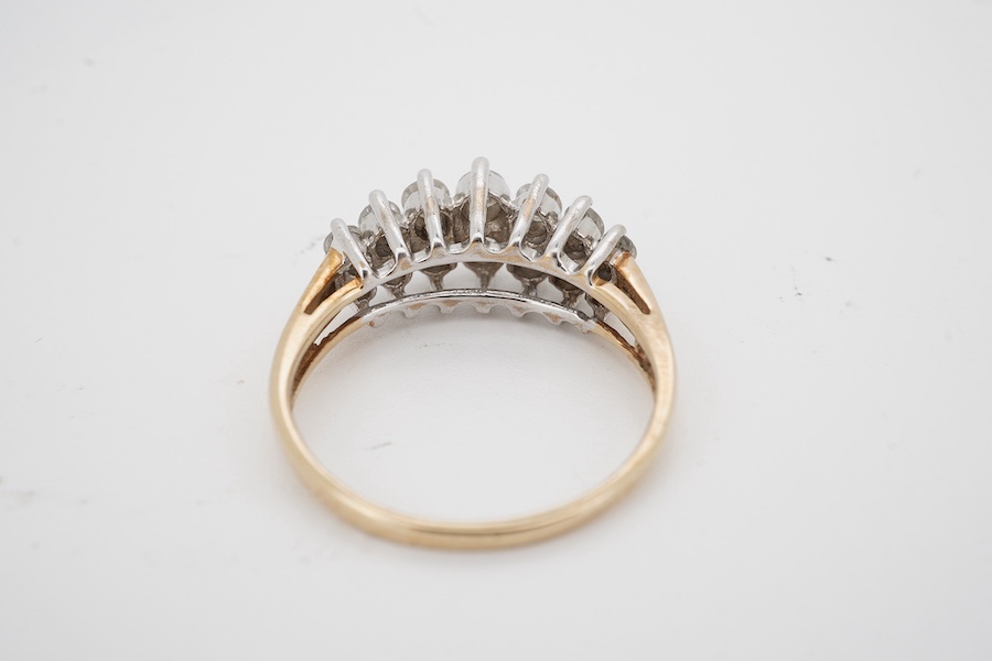 A modern 9ct gold and diamond half hoop ring, set with two graduated rows of seven diamonds, size M/N, gross weight 3.1 grams. Condition - fair to good